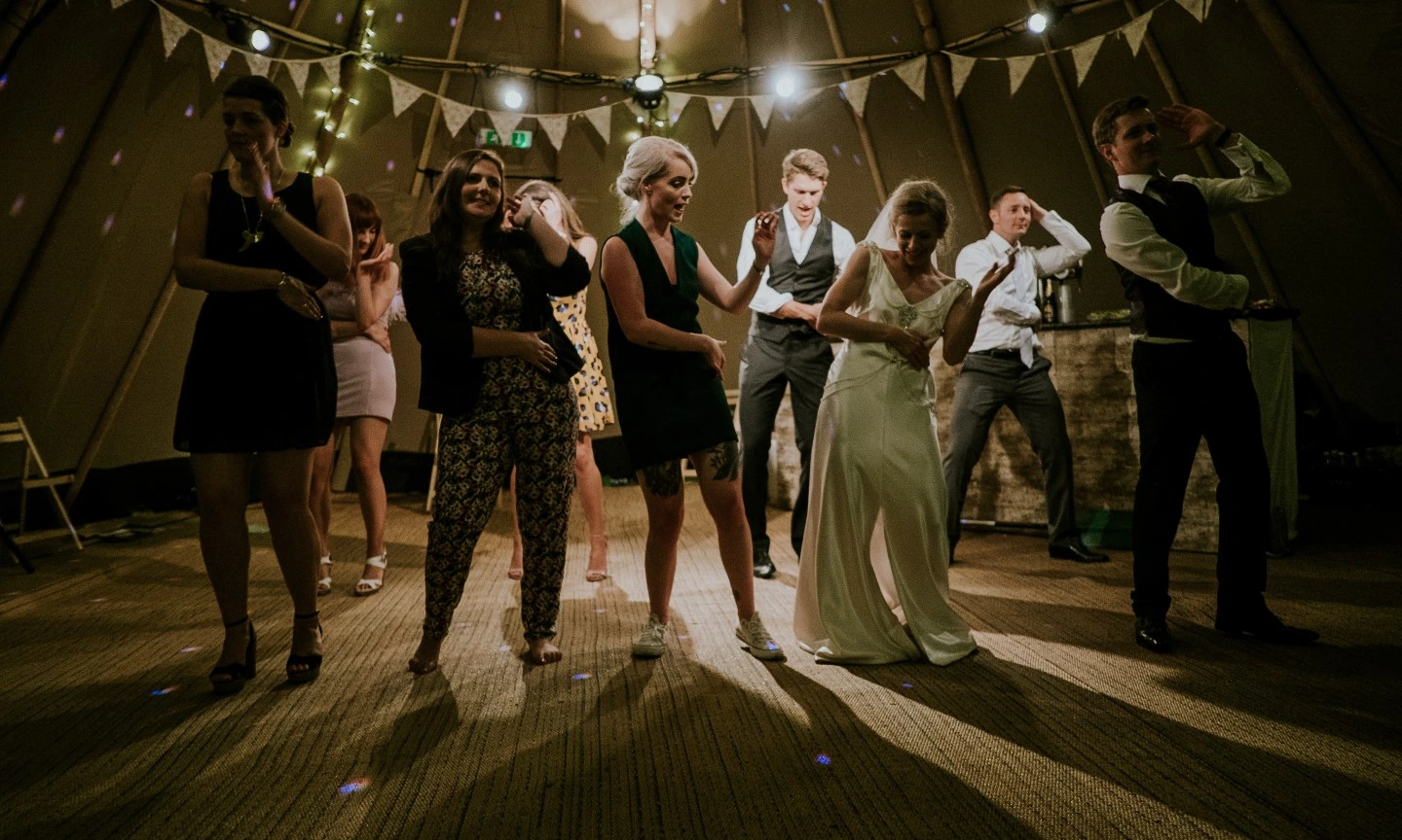 wedding guests and bride on the dance floor. Photo by Mitchell Orr via unsplash