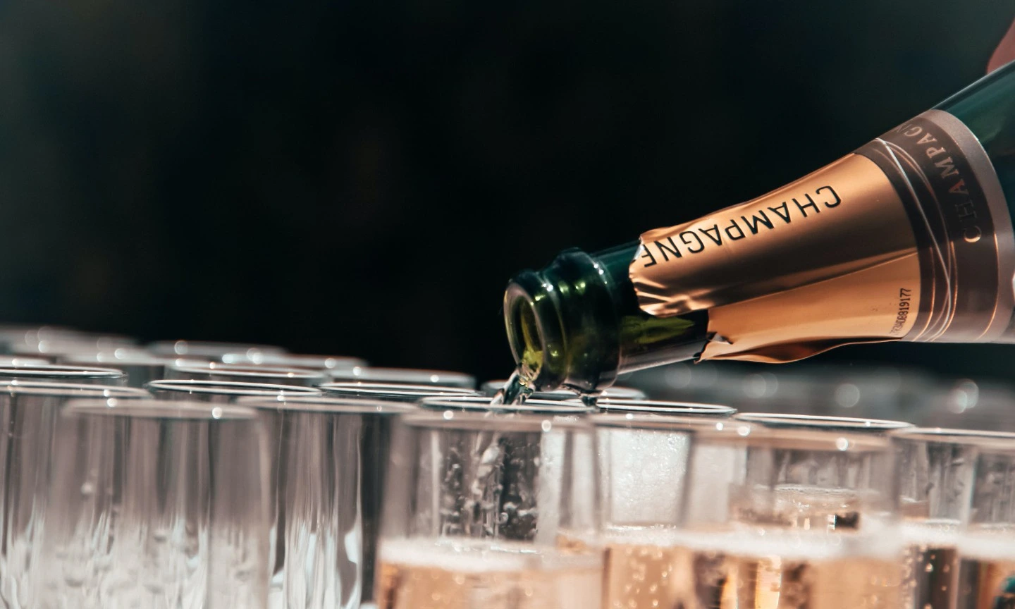 Glasses being filled with Champagne. Photo by tristan gassert via unsplash